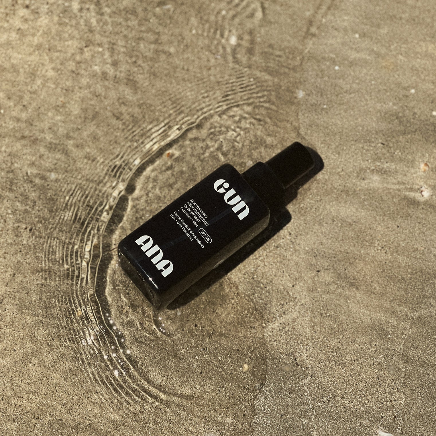 Gun Ana UV Body Mist chilling in the sand.